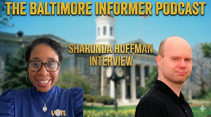 Featured graphic for 'The Baltimore Informer Podcast.' Gold text at the top reads 'THE BALTIMORE INFORMER PODCAST' and 'SHARONDA HUFFMAN INTERVIEW' below it. A photo of Sharonda Huffman is on the left, and the podcast host is on the right, set against a blurred backdrop of the Baltimore County Historic Courthouse.
